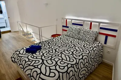 a bedroom with a black and white bed in a room at Oporto Blue Boavista - Deluxe City Center Duplex in Porto