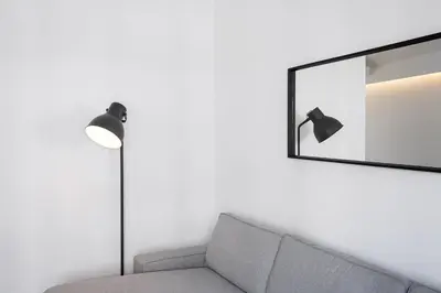 a living room with a couch and a mirror at GuestReady - Relaxing moment in a vibrant city in Porto