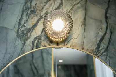 a chandelier hanging from a stone wall at GuestReady - Relaxing moment in a vibrant city in Porto