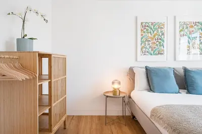 a bedroom with a bed and a book shelf at GuestReady - Relaxing moment in a vibrant city in Porto