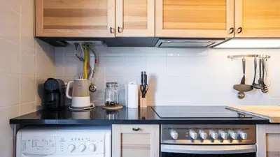 a kitchen with a stove and a counter top at Capelo Residency by LovelyStay in Porto
