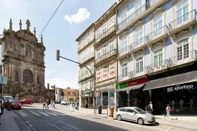 a street with a car parked in front of buildings at Boutique Rentals- THE CLéRiGoS Apt w/ patio in Porto