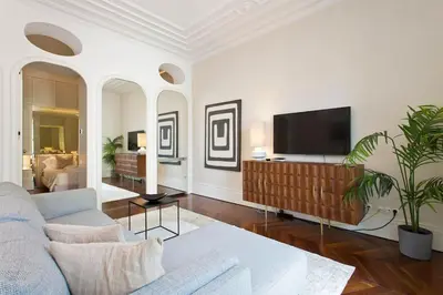 a living room with a couch and a flat screen tv at Boutique Rentals- THE CLéRiGoS Apt w/ patio in Porto