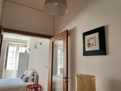 a bedroom with a bed and a mirror at Douro River Cozy Flats in Porto