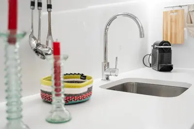 a kitchen counter top with a sink and a sink at GuestReady - Porto's Charming Escape in Porto