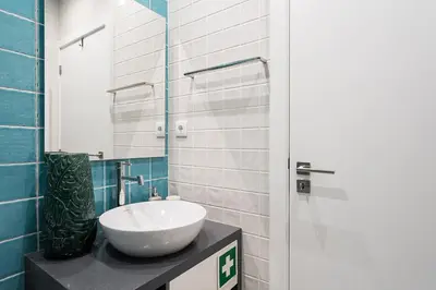 a bathroom with a white sink and a mirror at GuestReady - Porto's Charming Escape in Porto