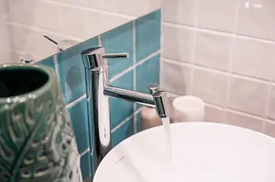 a sink in a bathroom with a faucet at GuestReady - Porto's Charming Escape in Porto