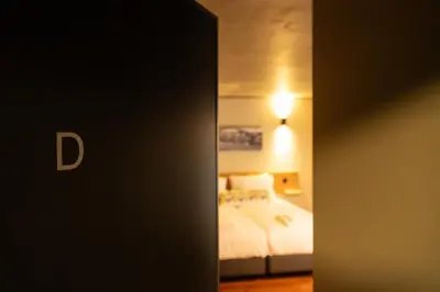 a hotel room with a bed and a light at Fervença Suites in Vila Nova de Gaia