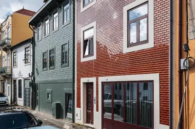 a red brick building on the side of a street at Fervença Suites in Vila Nova de Gaia