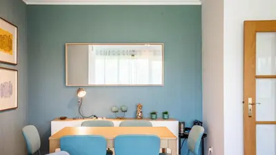 a dining room with a table and blue chairs at Infante Cozy 1BR w Parking by LovelyStay in Vila Nova de Gaia