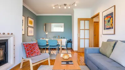 a living room with a couch and a table at Infante Cozy 1BR w Parking by LovelyStay in Vila Nova de Gaia