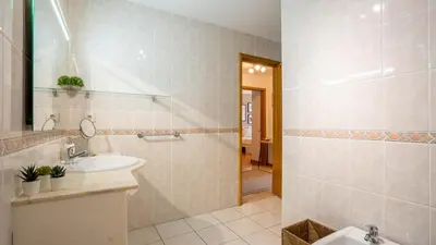 a bathroom with a sink and a mirror at Infante Cozy 1BR w Parking by LovelyStay in Vila Nova de Gaia