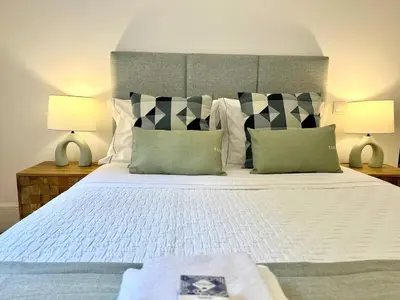 a bedroom with a large bed with two lamps at The Green House - Oporto Charming Apartment in Porto