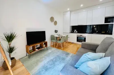 a living room with a couch and a tv at The Green House - Oporto Charming Apartment in Porto