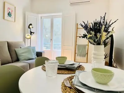 a living room with a table and a couch at The Green House - Oporto Charming Apartment in Porto