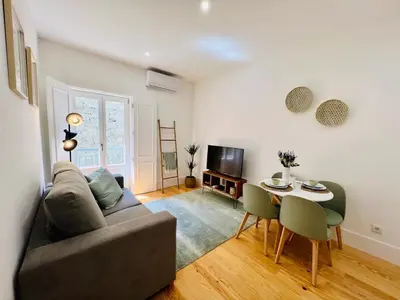 a living room with a couch and a table at The Green House - Oporto Charming Apartment in Porto