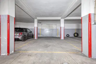 a parking garage with two cars parked in it at OPORTO GUEST Lobo Flat with Parking in Porto