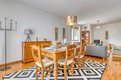 a dining room with a wooden table and chairs at OPORTO GUEST Lobo Flat with Parking in Porto