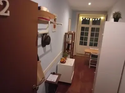 a small room with a kitchen and a hallway at Oupas 2 Lofts in Porto