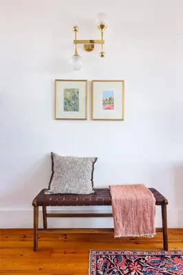a bench in a living room with two pictures on the wall at Stylish Loft in the city centre in Porto