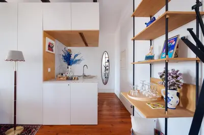 a kitchen with white cabinets and a sink at Stylish Loft in the city centre in Porto
