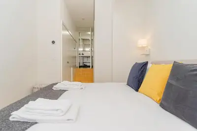 a bedroom with a white bed with towels on it at Charming Apartment • Porto in Porto