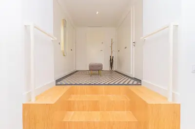 a hallway with a chair in the middle of a room at Charming Apartment • Porto in Porto
