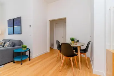 a living room with a table and chairs and a couch at Charming Apartment • Porto in Porto