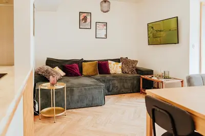 a living room with a couch and a table at Central apartment w/ garden terrace in Porto