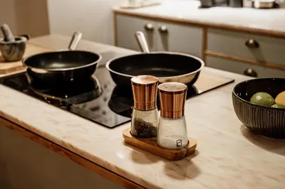 a kitchen counter with two pots on a stove at Central apartment w/ garden terrace in Porto