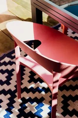 a red chair sitting on top of a rug at Central apartment w/ garden terrace in Porto