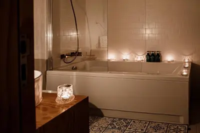 a bathroom with a bath tub and a sink at Central apartment w/ garden terrace in Porto