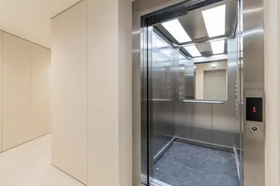 a elevator in a building with a glass door at T2 Constituição in Porto