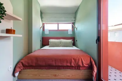 a small bedroom with a bed with a red blanket at Trendy & Charming Apartment • Porto city center in Porto