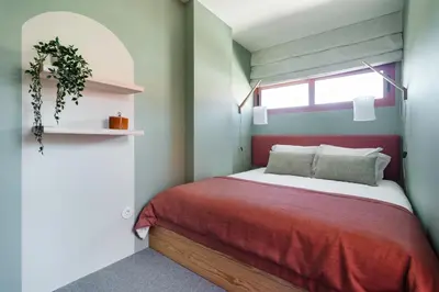 a bedroom with a red bed and a window at Trendy & Charming Apartment • Porto city center in Porto