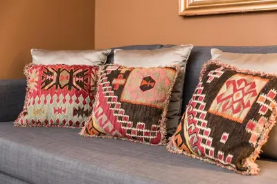 a couch with four pillows on top of it at Cute 1-bedroom next to Douro River in Porto