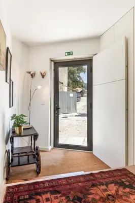 a room with a door leading to a patio at Cute 1-bedroom next to Douro River in Porto
