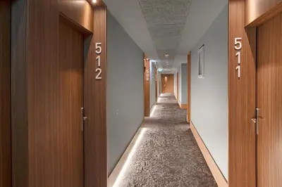 a hallway with wooden doors and a long aisle at B&B HOTEL Porto Gaia in Vila Nova de Gaia