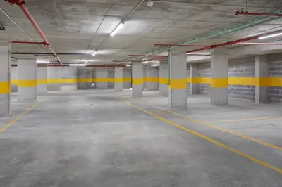 an empty parking garage with yellow lines on the walls at B&B HOTEL Porto Gaia in Vila Nova de Gaia