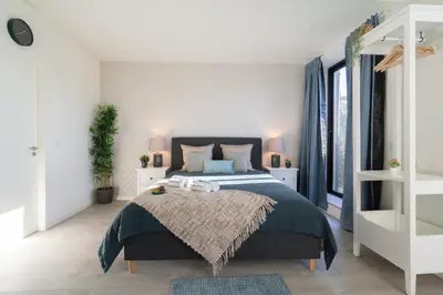 a bedroom with a bed and a large window at Host Wise - Central Private Flats - Terrace in Porto