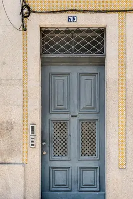 a blue door of a building with a sign above it at Santa Catarina Studio Apartments in Porto