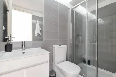 a bathroom with a toilet and a sink and a shower at Santa Catarina Studio Apartments in Porto