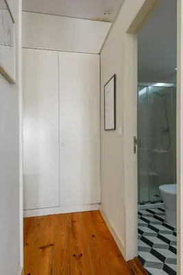 a bathroom with a toilet and a glass shower at Santa Catarina Studio Apartments in Porto