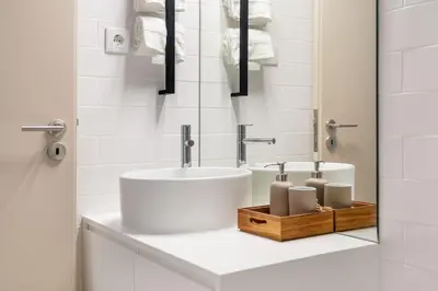 a white bathroom with two sinks and towels at Stylish apartment in city center in Porto