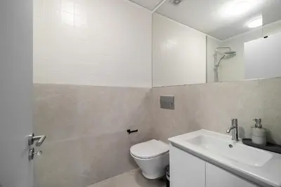 a bathroom with a toilet and a sink and a mirror at WHome Prime Portal to Porto Your Gateway to Urban Wonders in Porto