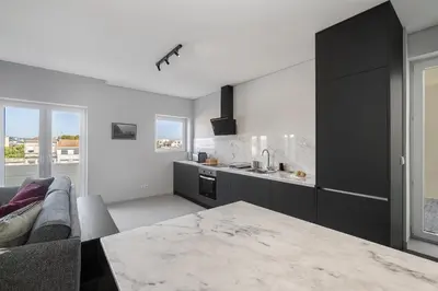 a kitchen with a couch and a table in a room at WHome Prime Portal to Porto Your Gateway to Urban Wonders in Porto