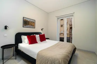 a bedroom with a large bed with red pillows at WHome Prime Portal to Porto Your Gateway to Urban Wonders in Porto