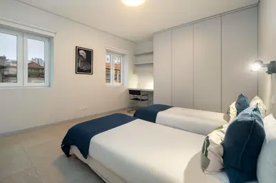 a bedroom with two beds and a window at WHome Prime Portal to Porto Your Gateway to Urban Wonders in Porto