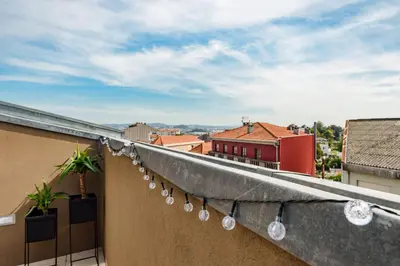 a balcony with lights on the side of a building at Lovely 2-bed in the city centre with a sunny balcony in Porto