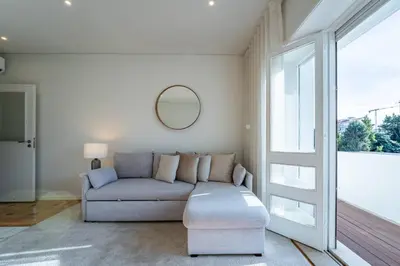 a couch with pillows on it next to at Brittos Avenue Apartment in Gaia in Vila Nova de Gaia